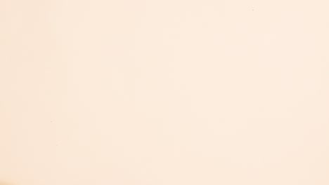 autumn fruits, leaves, pumpkins, berries and nuts appear on beige background with copy space. stop motion