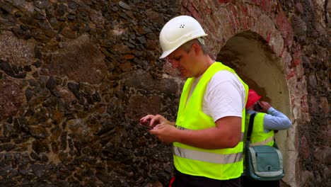 engineers inspecting the old wall