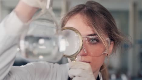 doctor woman examines water magnifier