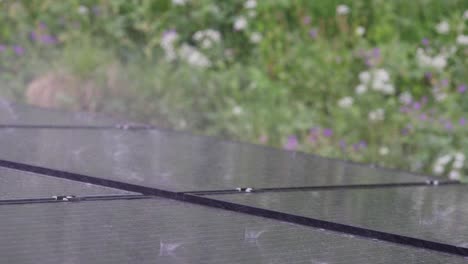 sheets of rain hitting array of residential solar panels during storm