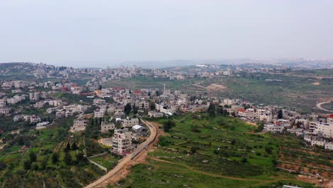 aerial view of a middle eastern town or village nestled in green hills