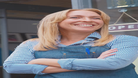 vertical video portrait of female owner or staff standing outside coffee shop