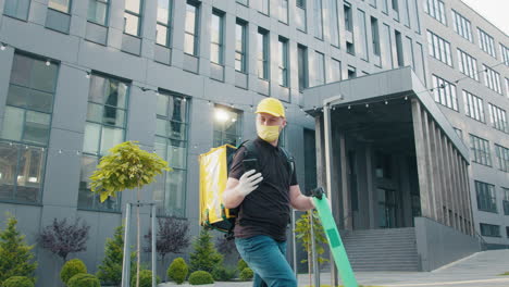 delivery person with backpack and mask in urban setting