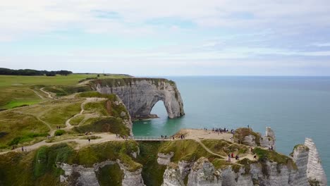 flying upwards and turning towards the arch of etretat and the sea