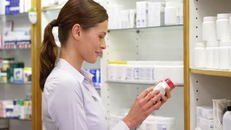 Pharmacist-checking-a-bottle-of-drug