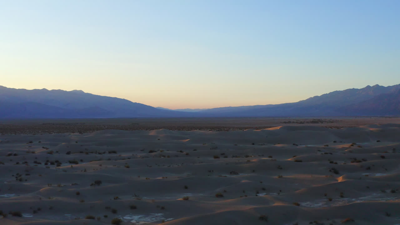 Cinematic view of sand dunes in sunset light. Death Valley desert national park, California. Drone ascending