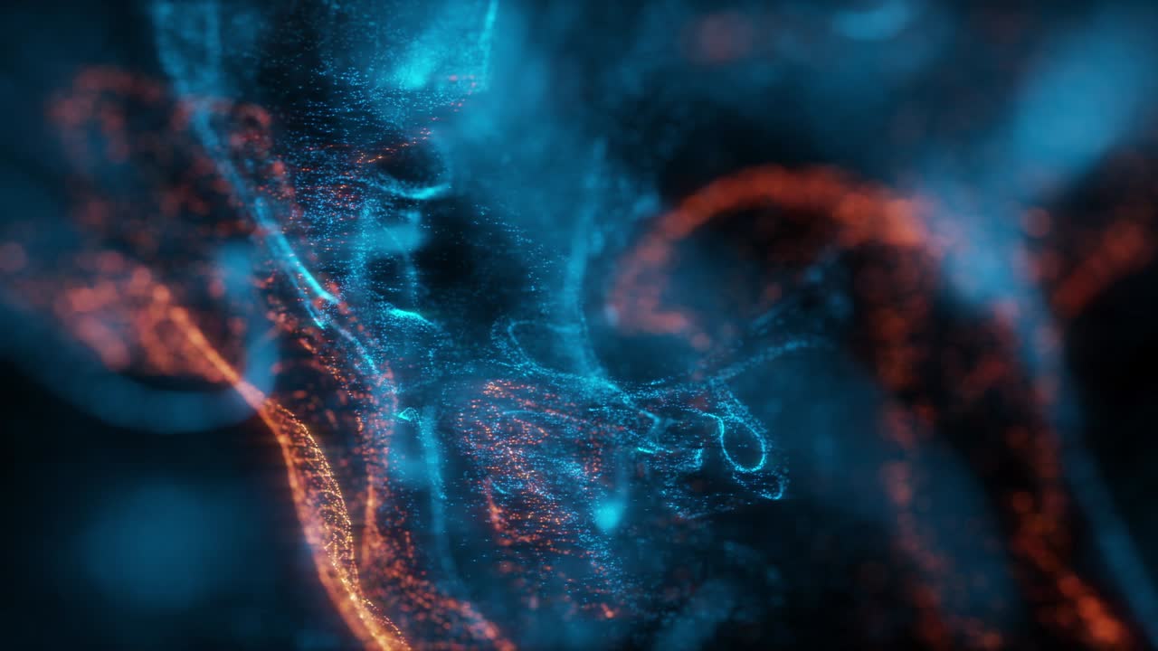 macro abstracto en cámara lenta de fluido de partículas azules y naranjas aisladas en negro.