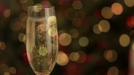 Animation-of-champagne-being-poured-into-glass-over-fairy-lights-flickering