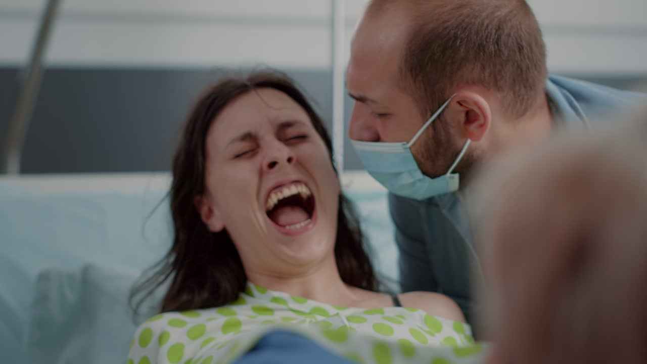 Close up of pregnant woman pushing and screaming