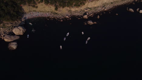 aerial view of a beach with boats and people