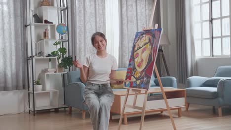 woman painting a portrait at home