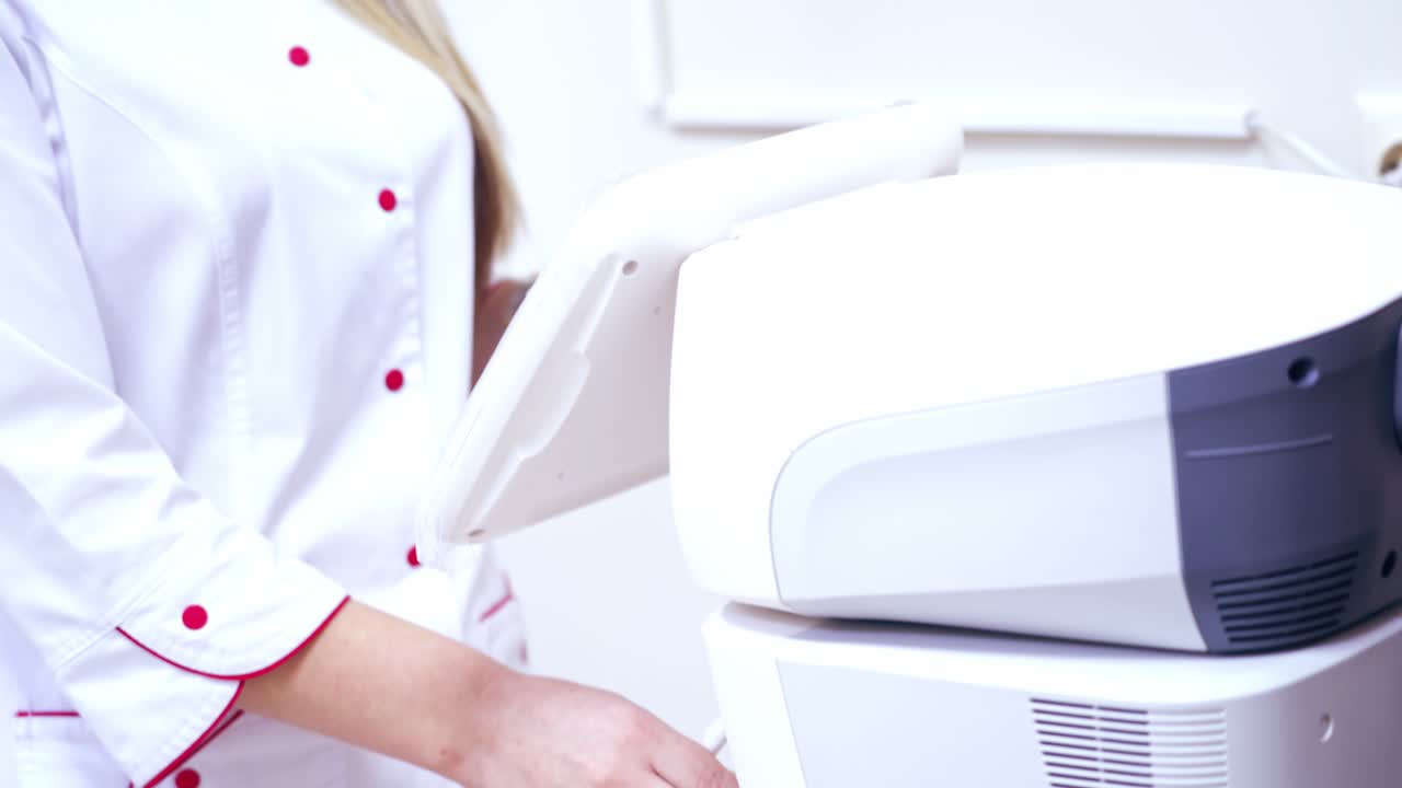 Woman checks eyesight. Woman checking vision with tonometer at eye clinic