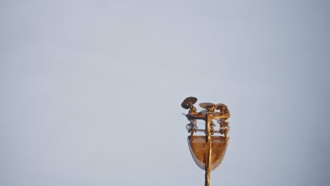 gold earring of a scythian priestess 2000 years old, an old earring, spinning wheel, found during excavations. vintage jewelry. religion. close-up