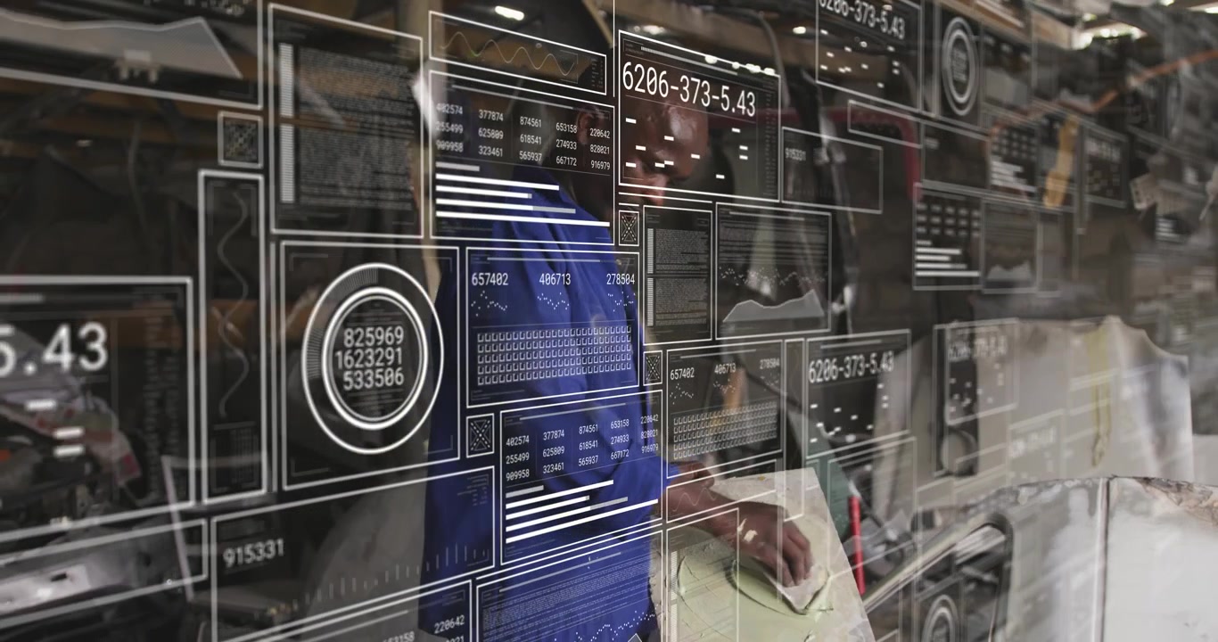 Male tech lifting panel in auto shop, inspecting seams for fit while HUD overlaying readouts