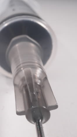 new syringe with open needle on white background macro view. injection tool to cure patient. sterile disposable medical supplies for hospitals