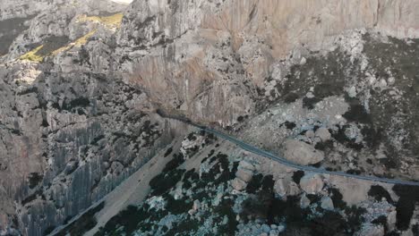 aerial, drone shot following cars driving through the soller road tunnel, in the mountains, in mallorca, spain