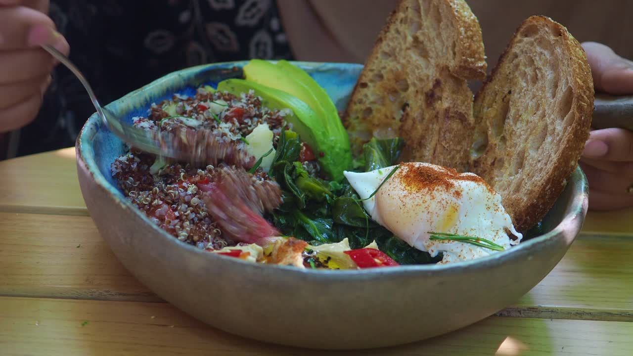 Quinoa salad with avocado, toast and egg