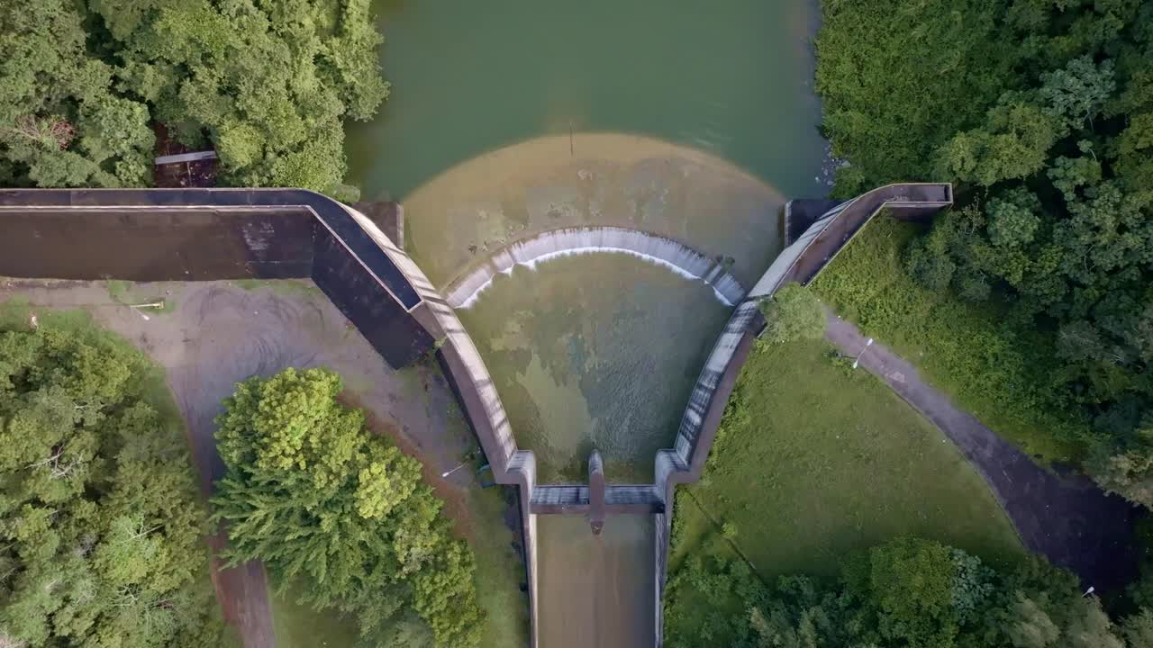 High-angle drone view of Hatillo Dam spillway, concrete structure, ideal for environmental, infrastructure, and hydroelectric themes. Aerial directly above