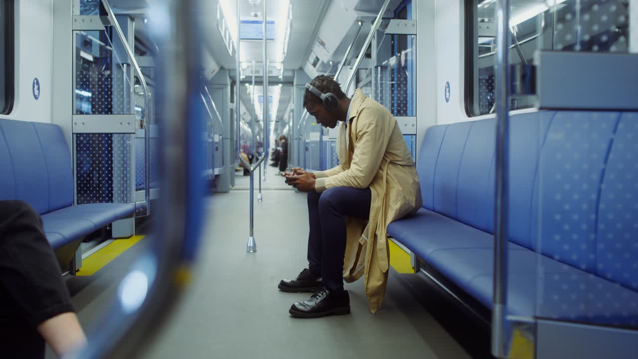 Man using smartphone on subway train