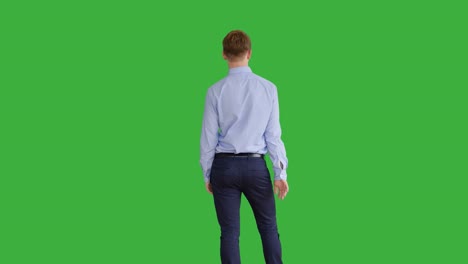 young caucasian man standing against green screen background. male person isolated on chroma key. casual business professional portrait