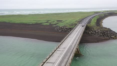 iceland car with bridge at black beach