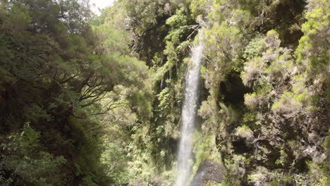 Drone-flight,-very-tight-plan-of-an-extraordinary-place-under-a-bridge-view-a-waterfall