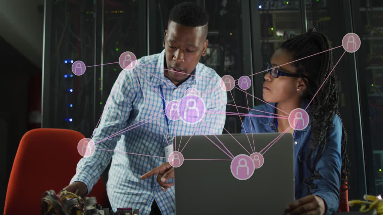 Animation of profile icons over african american male and female engineers discussing at server room