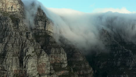 aerial: clouds falling table mountain in cape town