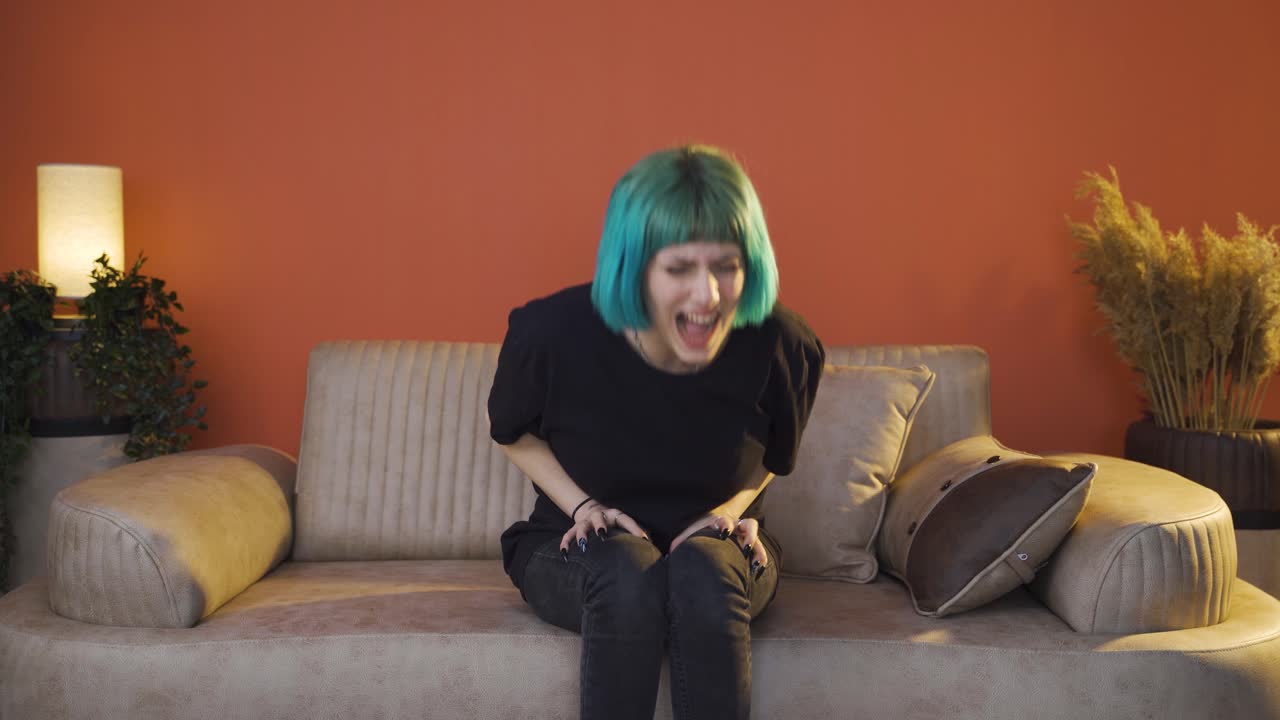 una mujer joven que tiene un colapso nervioso en casa está gritando.