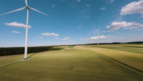 Sunny-day-wind-turbine-farm-from-above,-FPV-view