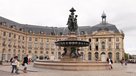 people walking around historic fountain