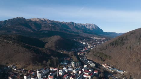 aerial hyperlapse shot above sinaia city and idyllic mountain range landscape in backdrop