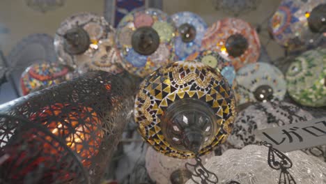 turkish glass mosaic lamps, bottom view. action. small traditional lanterns with colorful mosaic patterns hanging at the souvenir store