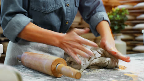 mid section of female potter molding a clay 4k