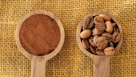 coffee beans and grounds in wooden spoons on burlap