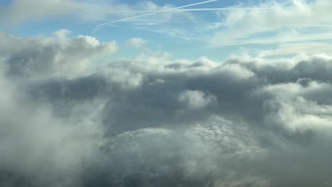 pilot pov flying across a sky with some fluffy clouds