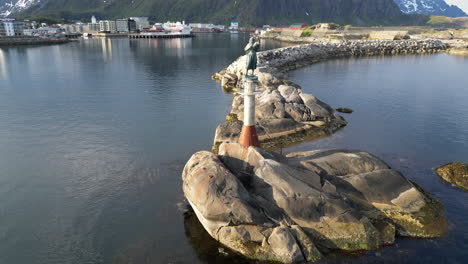 the fisherman's wife statue at sunset in the charming svolvaer harbor