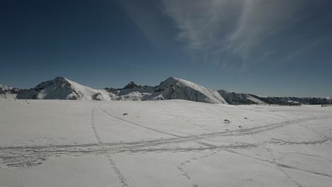 Skiing-with-a-beautiful-aerial-view-of-the-mountain-cover-with-snow-on-a-sunny-day