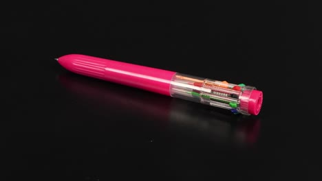 pen with colored refills on a black. ten different colors. side view. loop motion. rotation 360.