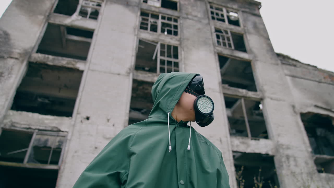 Human in radioactive hazmat standing in apocalypsis city. Protective ecology in radioactive mask.