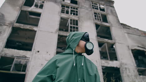 human in radioactive hazmat standing in apocalypsis city. protective ecology in radioactive mask.