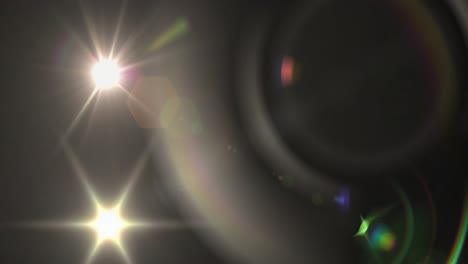 Animation-of-glowing-blue-particles-of-light-beams-with-lens-flare-on-dark-background