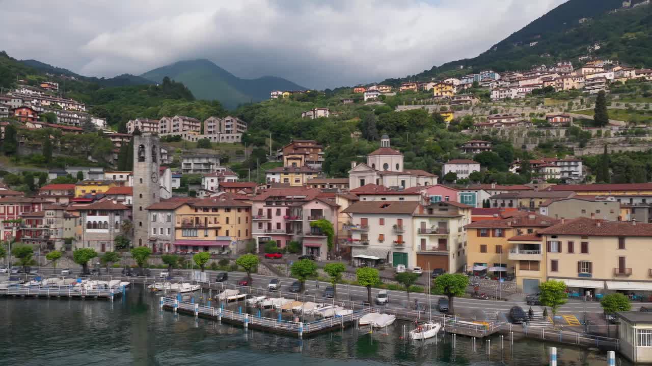 Charming aerial view of a lakeside Italian town with colorful buildings and a central bell tower by the marina