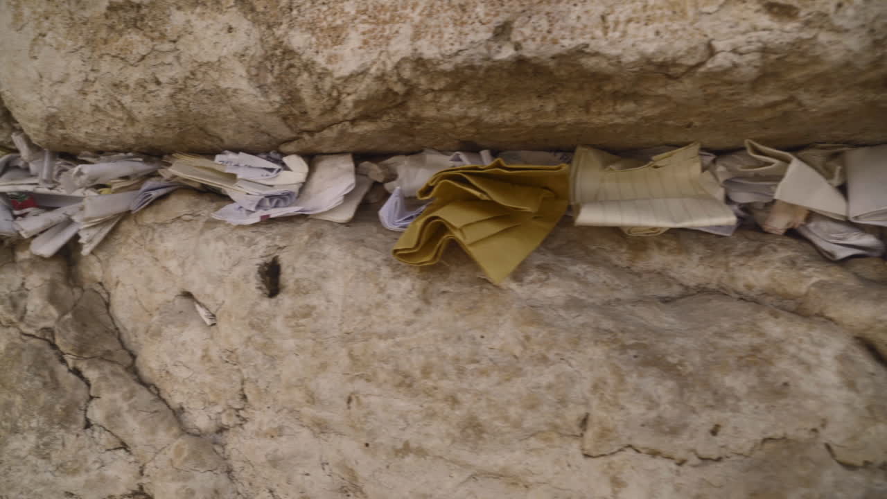 Religious prayers and notes stuffed into the cracks of the Western Wall in Jerusalem, Israel. Jewish and Islamic alike frequently visit this area.