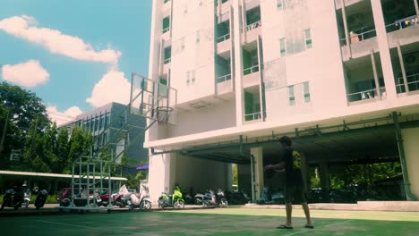 4K-Cinematic-sport-footage-of-a-man-playing-basketball-alone-outside-on-a-sunny-day