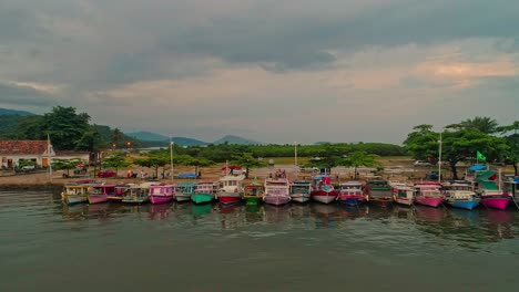 Aerial-dolly-shot-tracking-along-a-row-of-docked-boats-in-Paratay,-Brazil