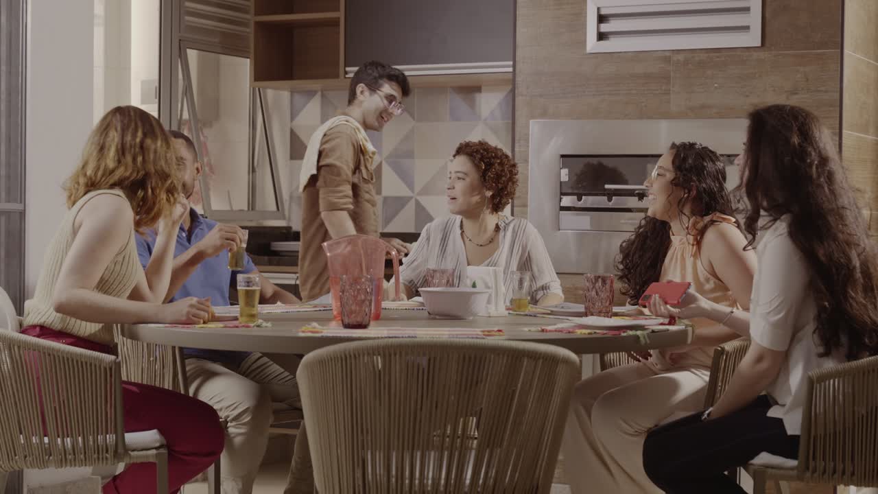 Diverse Group of Young Adults Enjoying a Social Gathering and Laughter