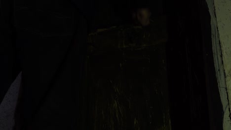 prison's guard closing the door of dungeon with iron bars window on background