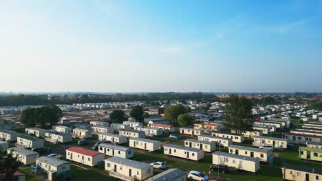 Aerial-film-captures-the-essence-of-Skegness's-holiday-parks,-with-caravans,-holiday-homes,-and-the-surrounding-countryside-on-a-summer-evening