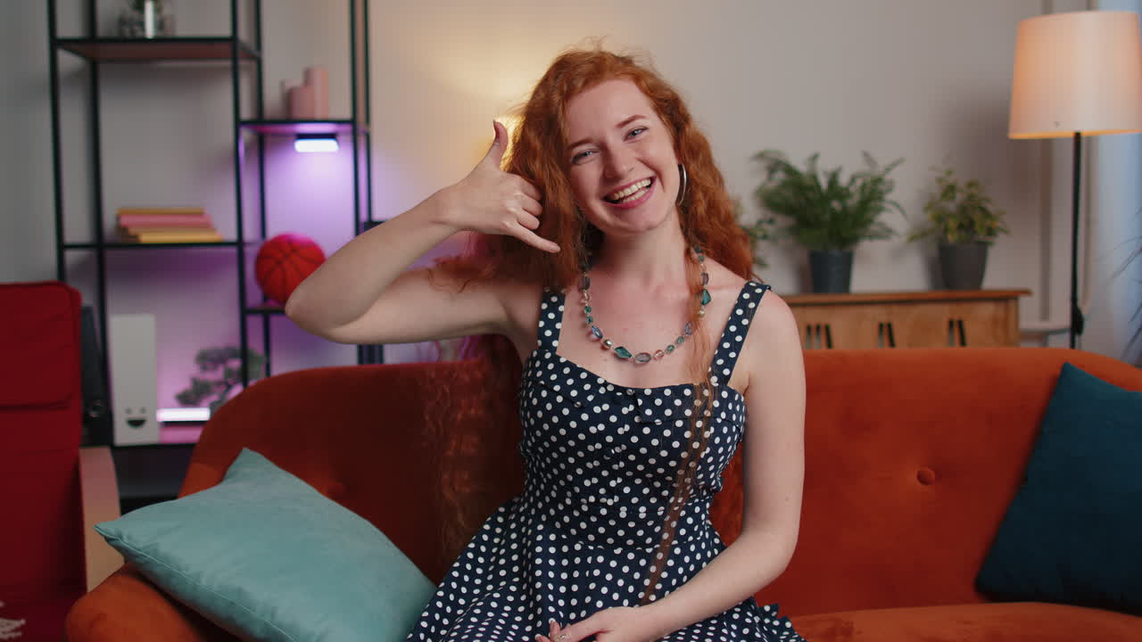 카메라 광고를 보는 여자가 전화 제스처를 하고 있습니다. "이봐요, 집에서 전화해 주세요"라고 합니다.